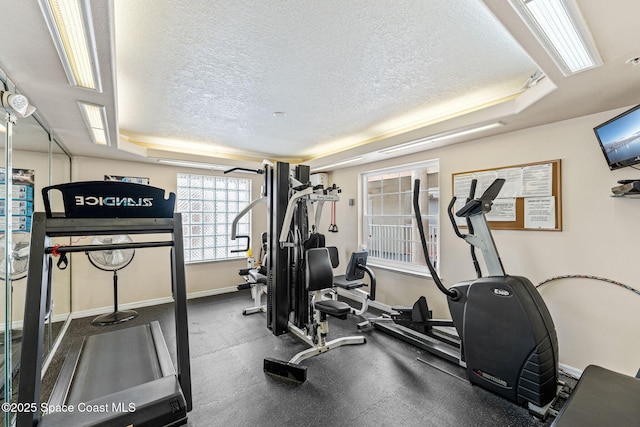 3360 S Atlantic Ave Unit 212, Cocoa Beach, FL 32931 - workout area featuring a textured ceiling and a tray ceiling