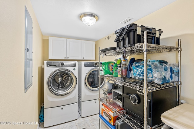 3360 S Atlantic Ave Unit 212, Cocoa Beach, FL 32931 - laundry area featuring cabinet space, washing machine and clothes dryer, and light tile patterned flooring