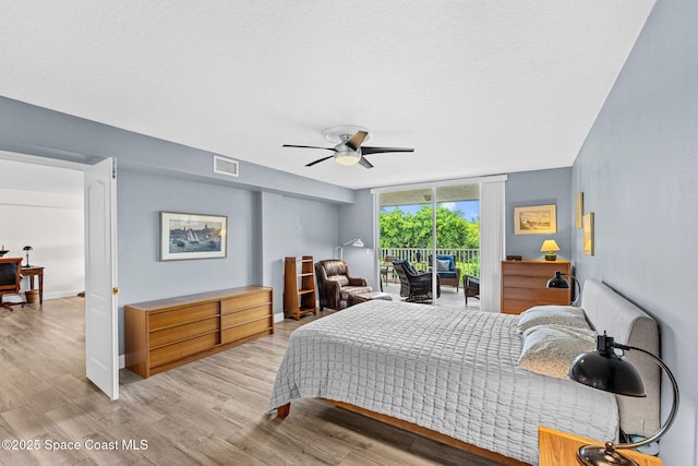 3360 S Atlantic Ave Unit 212, Cocoa Beach, FL 32931 - bedroom featuring access to exterior, light wood-style floors, and a ceiling fan