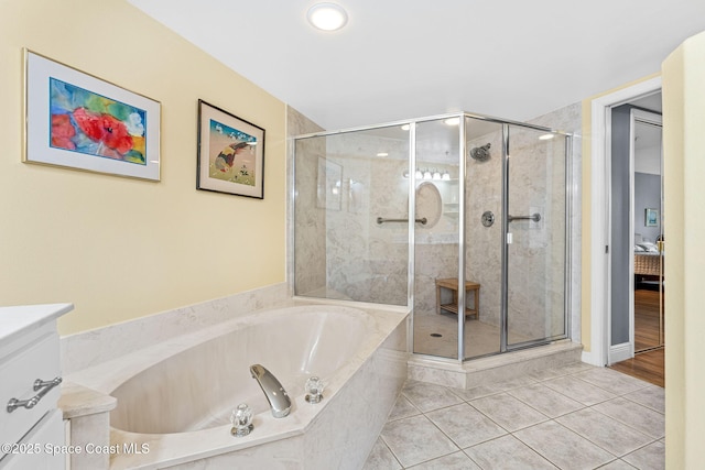 3360 S Atlantic Ave Unit 212, Cocoa Beach, FL 32931 - full bathroom featuring a garden tub, tile patterned flooring, a stall shower, and vanity