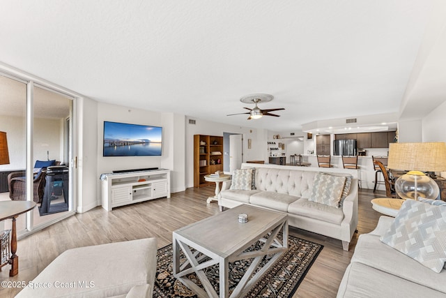 3360 S Atlantic Ave Unit 212, Cocoa Beach, FL 32931 - living room featuring light wood finished floors and a ceiling fan