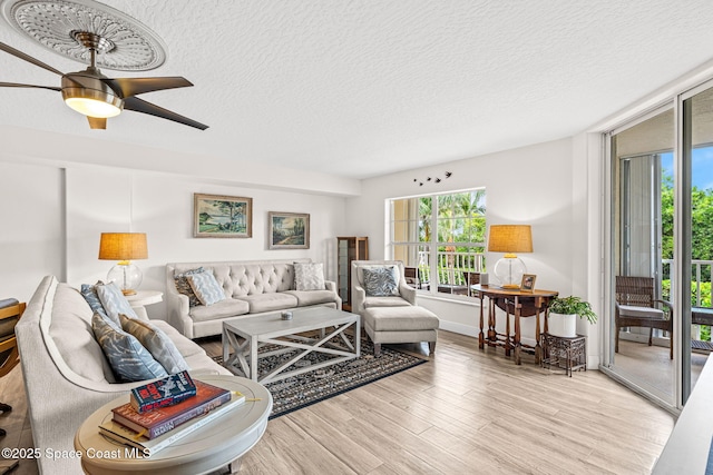 3360 S Atlantic Ave Unit 212, Cocoa Beach, FL 32931 - living room with a textured ceiling, wood finished floors, and a ceiling fan