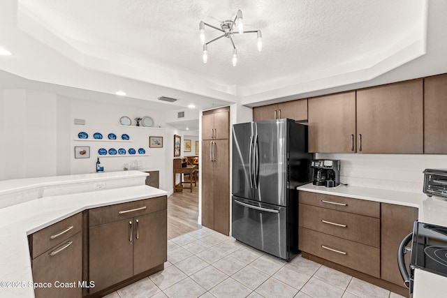3360 S Atlantic Ave Unit 212, Cocoa Beach, FL 32931 - kitchen featuring freestanding refrigerator, electric range oven, light countertops, light tile patterned floors, and a textured ceiling