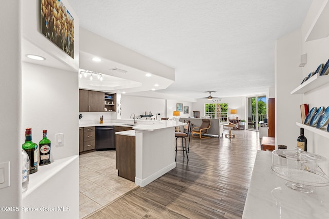 3360 S Atlantic Ave Unit 212, Cocoa Beach, FL 32931 - kitchen featuring open shelves, dishwasher, a breakfast bar, light countertops, and open floor plan