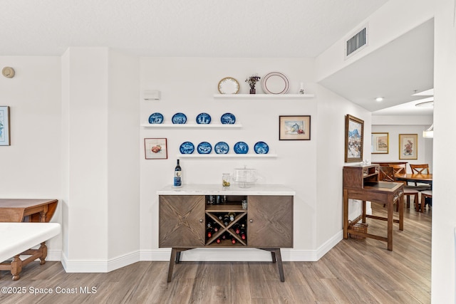 3360 S Atlantic Ave Unit 212, Cocoa Beach, FL 32931 - bar area featuring wood finished floors and baseboards