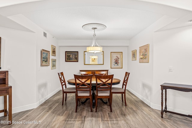 3360 S Atlantic Ave Unit 212, Cocoa Beach, FL 32931 - dining room with wood finished floors and baseboards