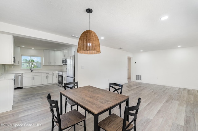 320 Alabama Ave, Merritt Island, FL 32953 - dining room with light wood-style floors and recessed lighting