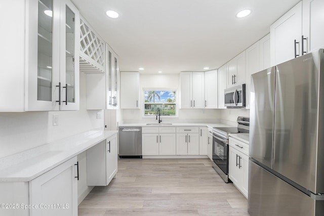 320 Alabama Ave, Merritt Island, FL 32953 - kitchen featuring stainless steel appliances, white cabinetry, recessed lighting, and glass insert cabinets