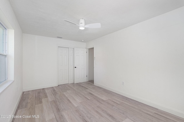 320 Alabama Ave, Merritt Island, FL 32953 - unfurnished bedroom with light wood-style floors, a closet, and ceiling fan