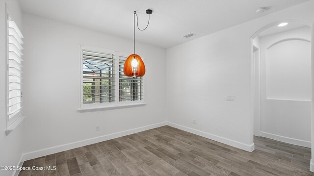 3110 Addison Dr, Melbourne, FL 32940 - unfurnished dining area featuring wood finished floors and arched walkways