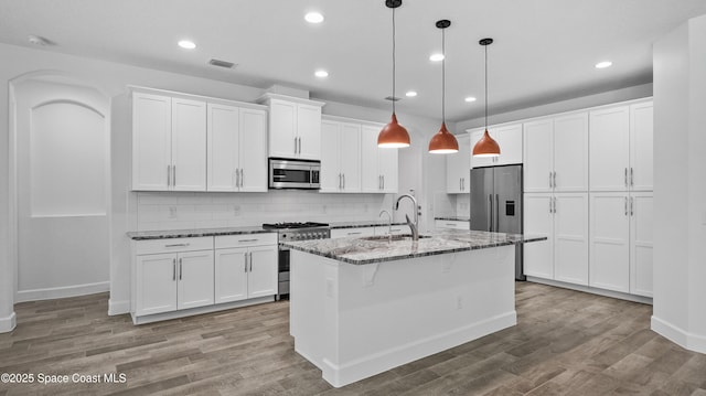 3110 Addison Dr, Melbourne, FL 32940 - kitchen featuring high end appliances, tasteful backsplash, white cabinetry, and recessed lighting