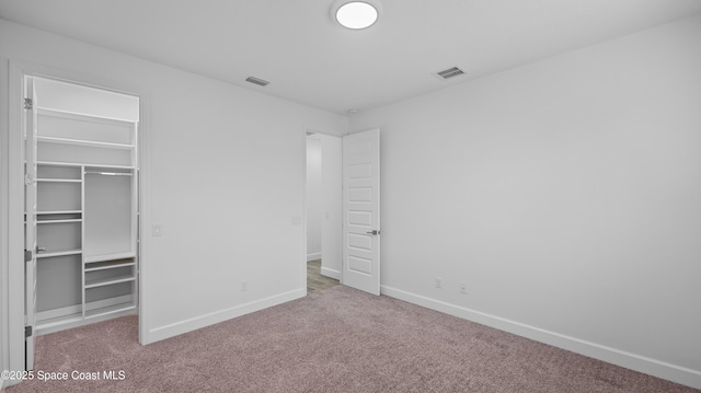 3110 Addison Dr, Melbourne, FL 32940 - unfurnished bedroom with carpet floors, a walk in closet, and a closet