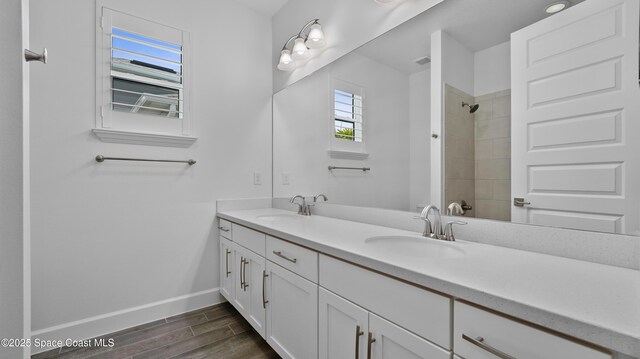 3110 Addison Dr, Melbourne, FL 32940 - full bath with double vanity, wood finished floors, and tiled shower