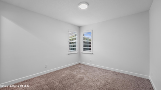 3110 Addison Dr, Melbourne, FL 32940 - empty room featuring carpet floors and baseboards