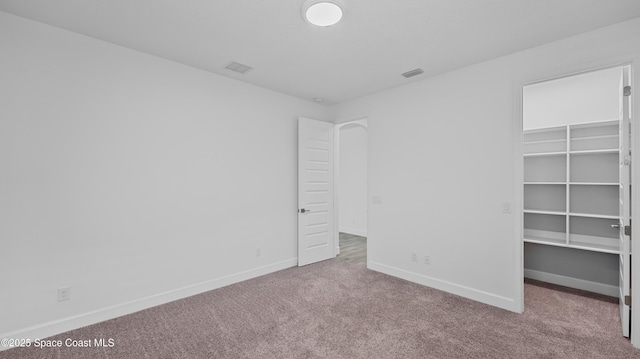3110 Addison Dr, Melbourne, FL 32940 - unfurnished bedroom featuring carpet flooring, a spacious closet, and a closet