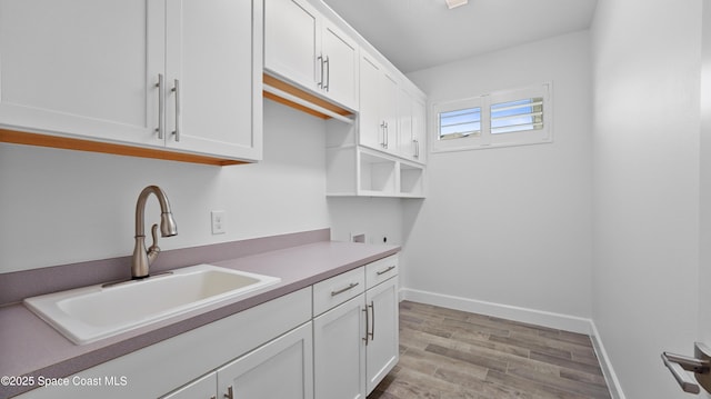 3110 Addison Dr, Melbourne, FL 32940 - kitchen with white cabinetry and light wood-type flooring