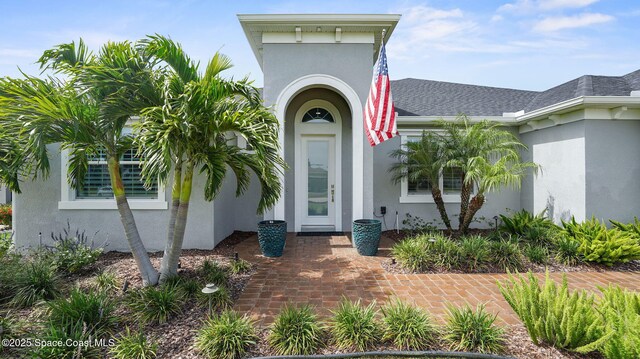 3110 Addison Dr, Melbourne, FL 32940 - property entrance with stucco siding and roof with shingles
