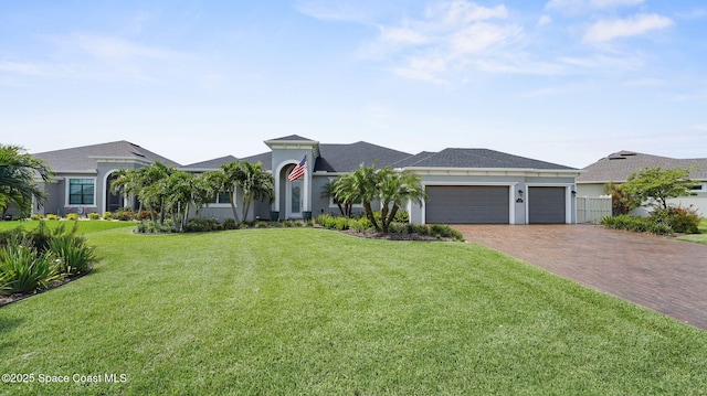 3110 Addison Dr, Melbourne, FL 32940 - view of front of property with decorative driveway, an attached garage, a front lawn, and stucco siding