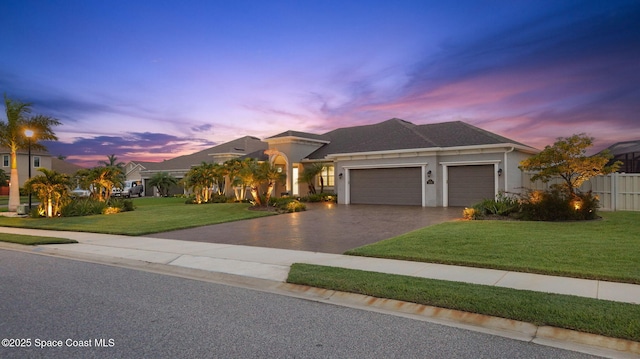 3110 Addison Dr, Melbourne, FL 32940 - view of front facade featuring an attached garage, asphalt driveway, and stucco siding