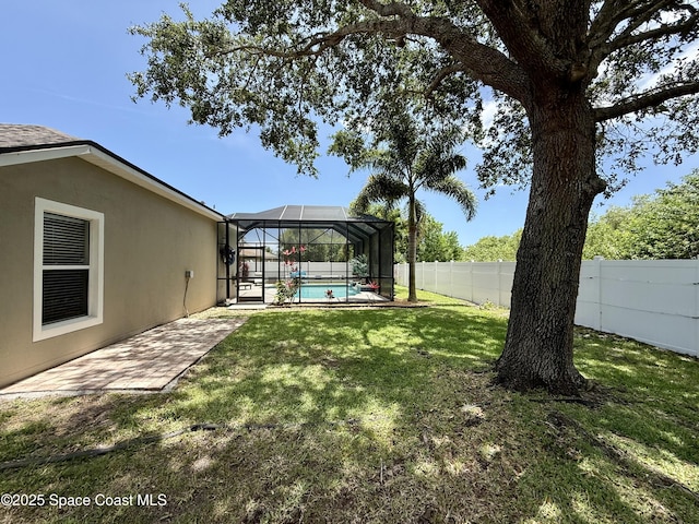 4569 Chastain Dr, Melbourne, FL 32940 - fenced backyard featuring a lanai and a patio