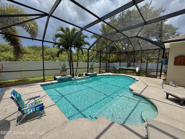 4569 Chastain Dr, Melbourne, FL 32940 - view of swimming pool with a fenced backyard, a patio, and a lanai