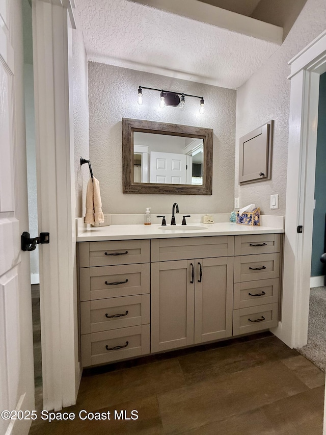 4569 Chastain Dr, Melbourne, FL 32940 - bathroom with a textured wall, vanity, and a textured ceiling