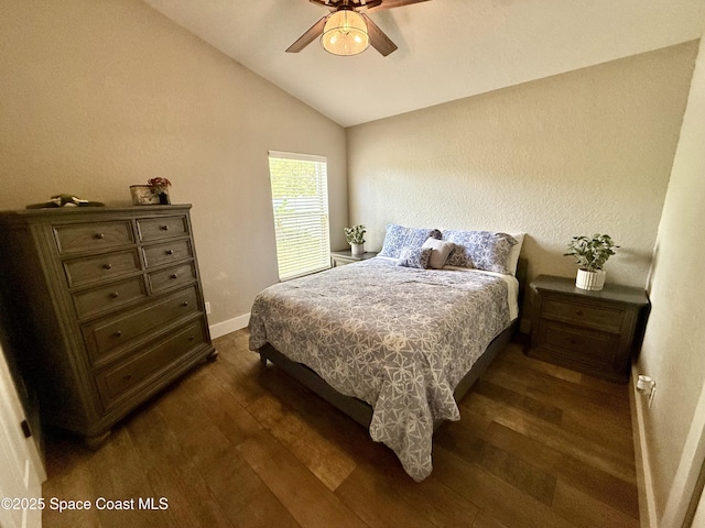 4569 Chastain Dr, Melbourne, FL 32940 - bedroom with dark wood-style floors, vaulted ceiling, and ceiling fan