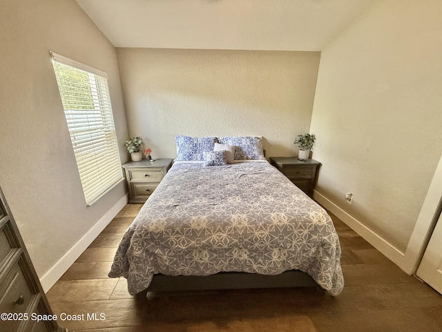 4569 Chastain Dr, Melbourne, FL 32940 - bedroom featuring dark wood-type flooring and vaulted ceiling