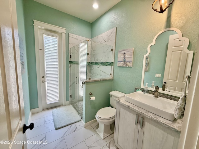 4569 Chastain Dr, Melbourne, FL 32940 - bathroom with a textured wall, vanity, a shower stall, and marble look tile flooring