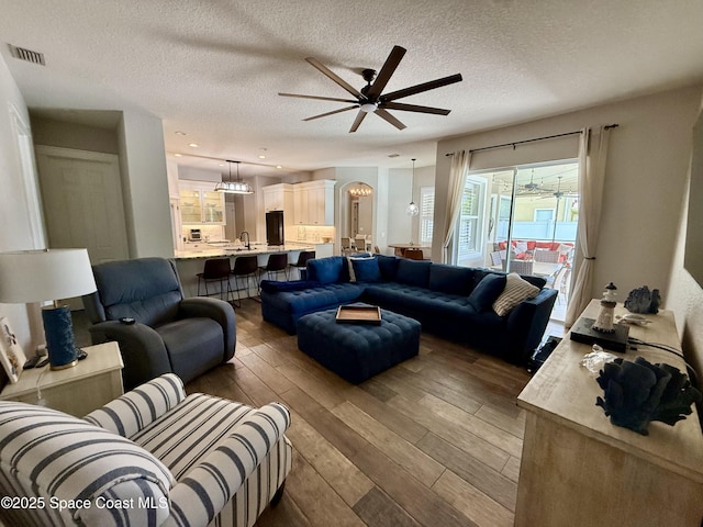 4569 Chastain Dr, Melbourne, FL 32940 - living area with a ceiling fan, wood-type flooring, and a textured ceiling