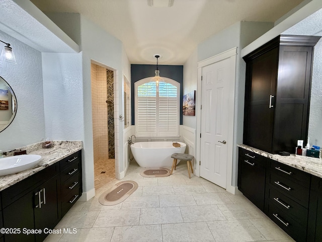 4569 Chastain Dr, Melbourne, FL 32940 - bathroom with a freestanding bath, vanity, and a tile shower