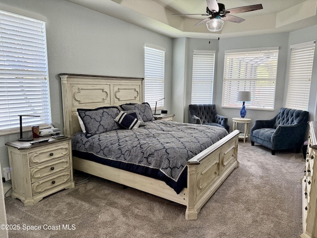 4569 Chastain Dr, Melbourne, FL 32940 - bedroom with light carpet, ceiling fan, and a raised ceiling