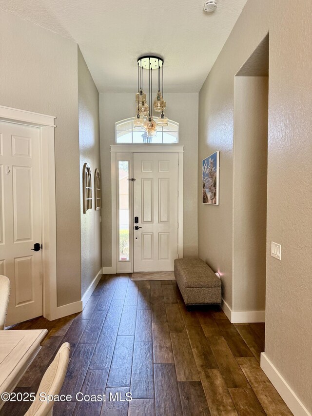 4569 Chastain Dr, Melbourne, FL 32940 - foyer entrance featuring dark wood-type flooring and a textured wall