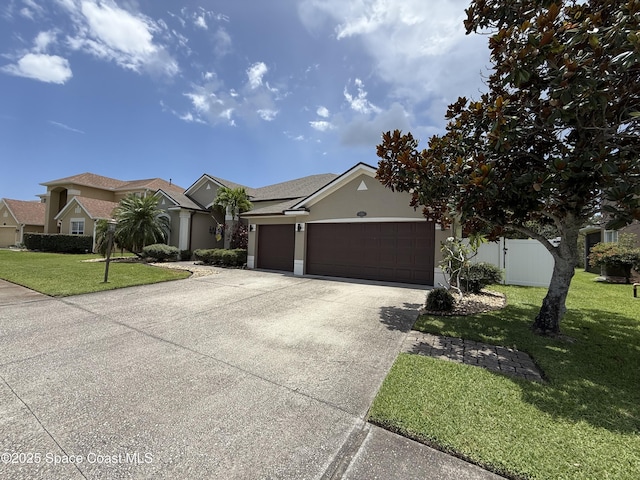 4569 Chastain Dr, Melbourne, FL 32940 - view of front of home with a garage, concrete driveway, stucco siding, and a front lawn