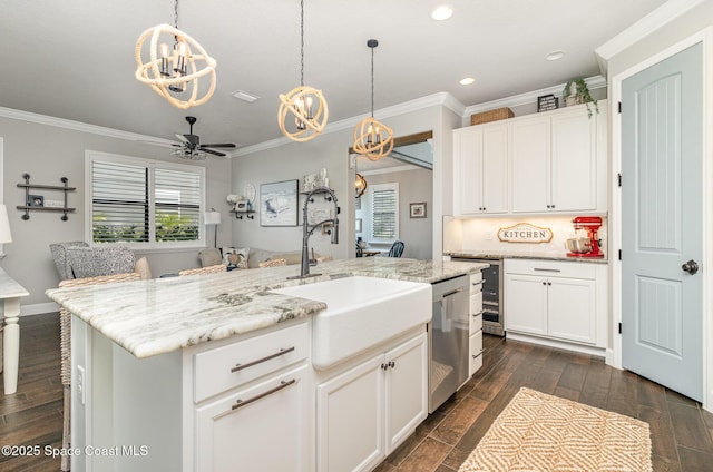 3243 Casare Dr, Melbourne, FL 32940 - kitchen with a chandelier, dishwasher, ornamental molding, dark wood-style flooring, and an island with sink