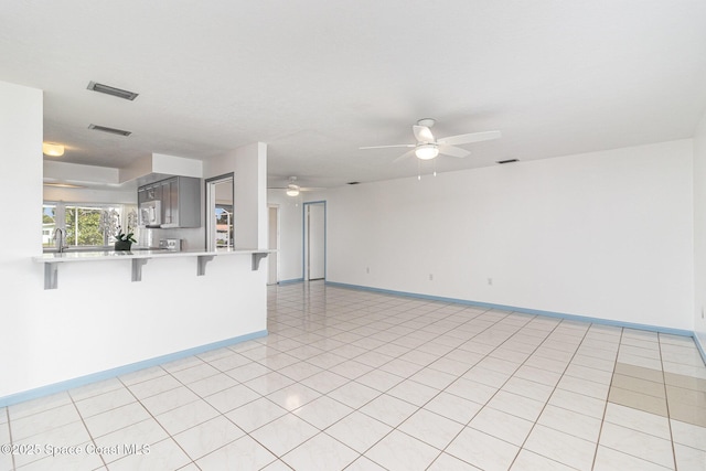 55 Yacht Haven Dr, Cocoa Beach, FL 32931 - unfurnished living room with a ceiling fan and light tile patterned floors
