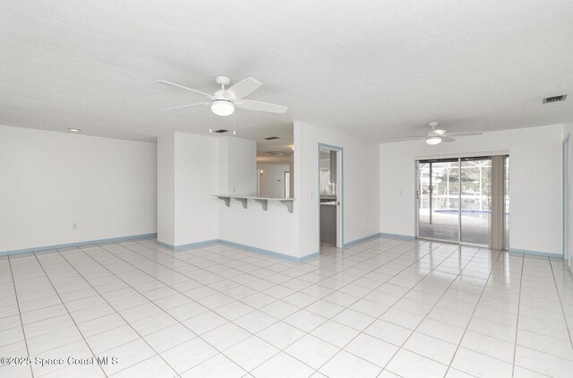 55 Yacht Haven Dr, Cocoa Beach, FL 32931 - unfurnished living room with ceiling fan and light tile patterned floors