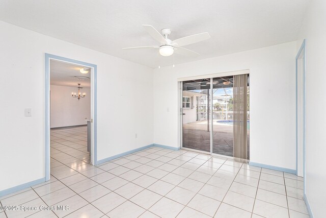 55 Yacht Haven Dr, Cocoa Beach, FL 32931 - empty room featuring light tile patterned floors, ceiling fan, and a chandelier