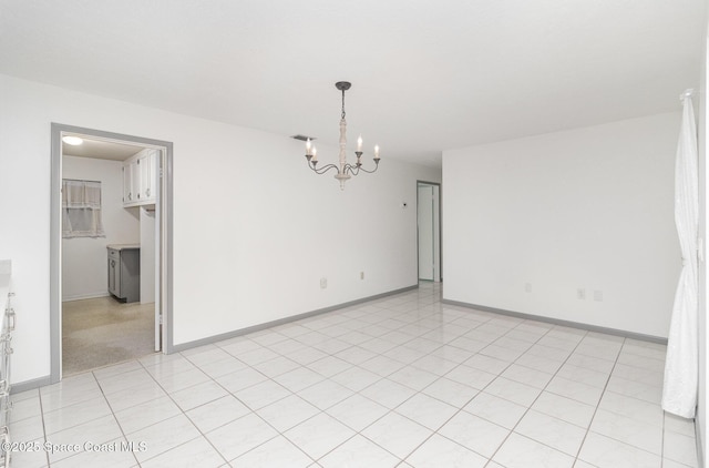 55 Yacht Haven Dr, Cocoa Beach, FL 32931 - empty room with a chandelier and baseboards