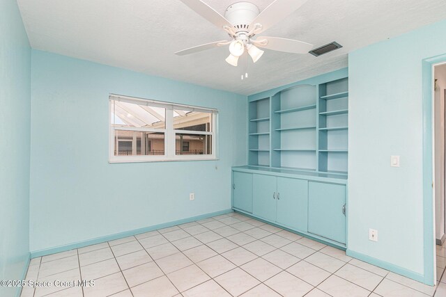 55 Yacht Haven Dr, Cocoa Beach, FL 32931 - unfurnished room featuring a ceiling fan and a textured ceiling