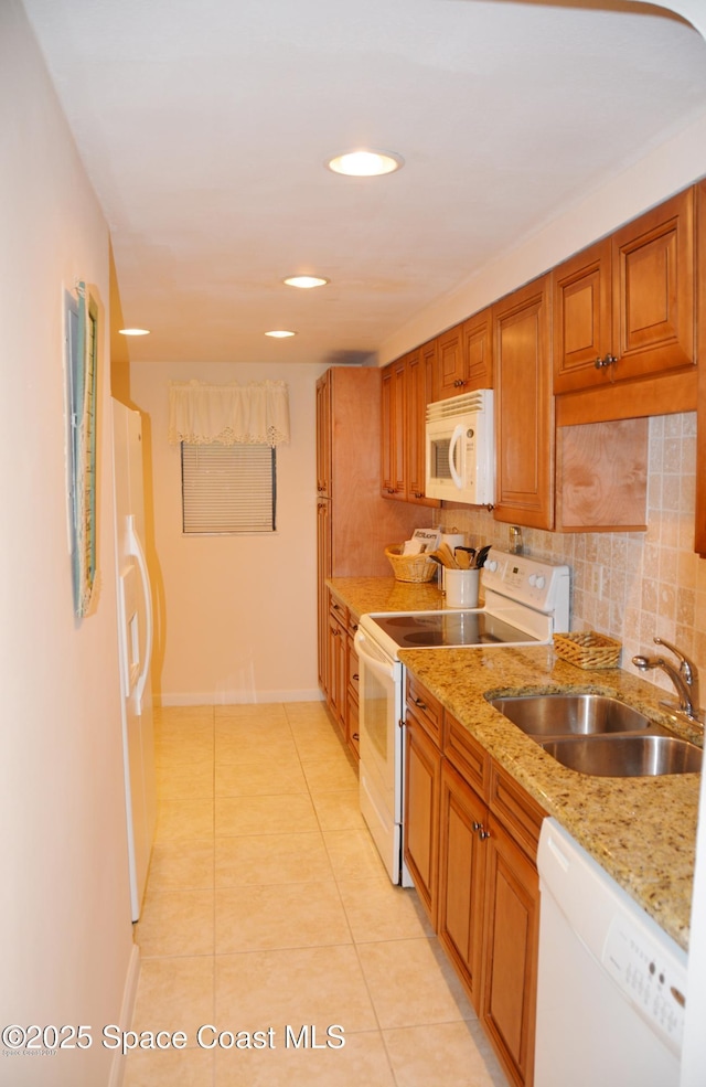 500 Palm Springs Blvd Unit 411, Indian Harbour Beach, FL 32937 - kitchen with white appliances, tasteful backsplash, brown cabinets, light tile patterned floors, and recessed lighting