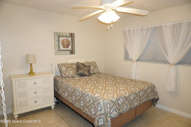 500 Palm Springs Blvd Unit 411, Indian Harbour Beach, FL 32937 - tiled bedroom with ceiling fan and baseboards