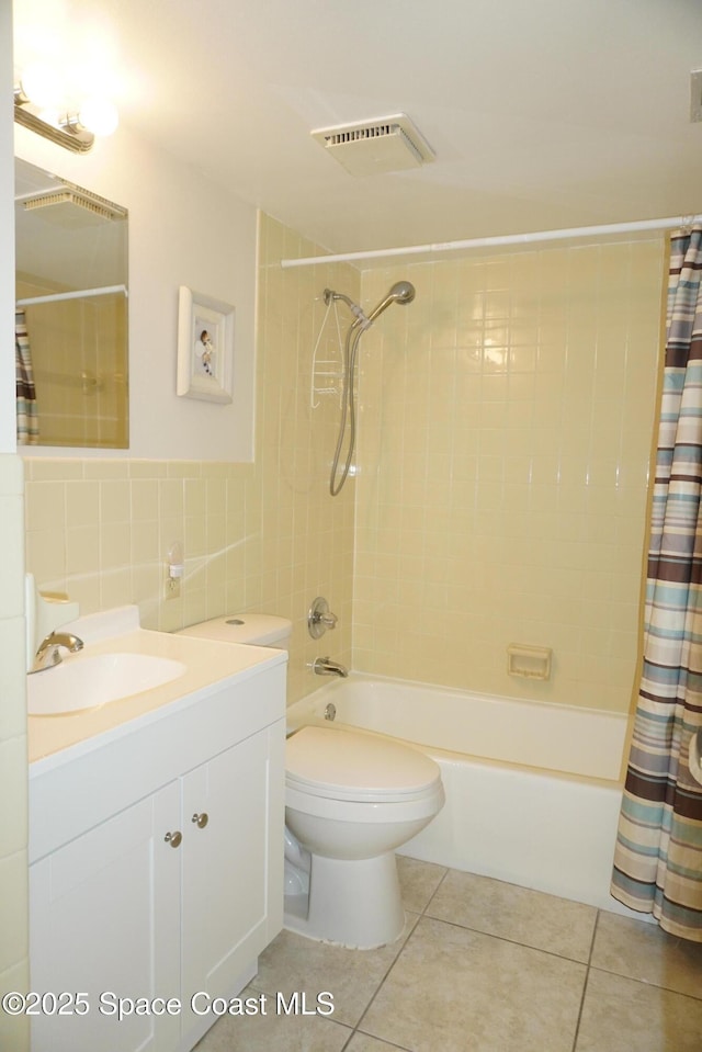 500 Palm Springs Blvd Unit 411, Indian Harbour Beach, FL 32937 - bathroom with tile walls, vanity, shower / bath combo with shower curtain, and tile patterned floors