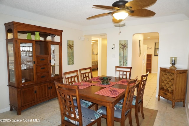 500 Palm Springs Blvd Unit 411, Indian Harbour Beach, FL 32937 - dining space featuring arched walkways, light tile patterned floors, a ceiling fan, and a textured ceiling