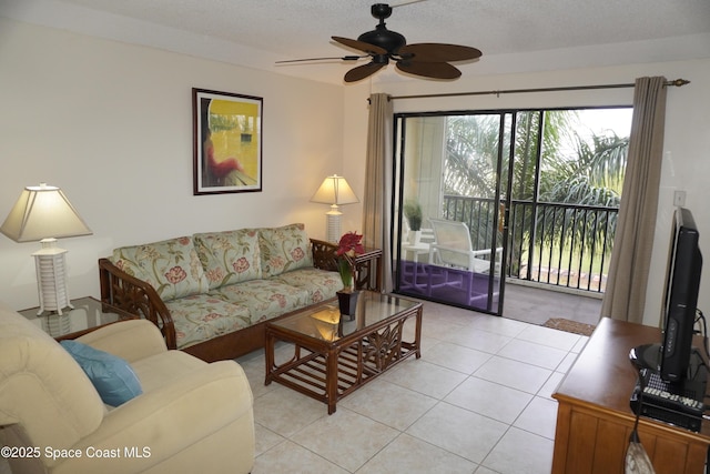500 Palm Springs Blvd Unit 411, Indian Harbour Beach, FL 32937 - living room with ceiling fan, light tile patterned floors, and a textured ceiling