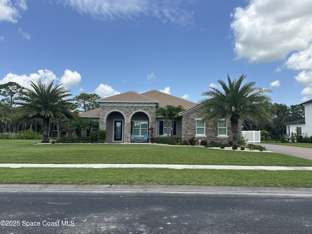 4357 Preservation Cir, Melbourne, FL 32934 - mediterranean / spanish-style home featuring a front lawn and a tiled roof