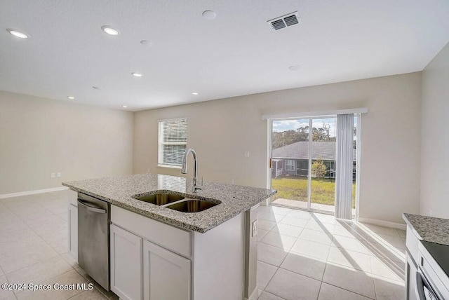 301 Latham St SE, Palm Bay, FL 32909 - kitchen with stainless steel dishwasher, light tile patterned floors, a center island with sink, recessed lighting, and light stone counters
