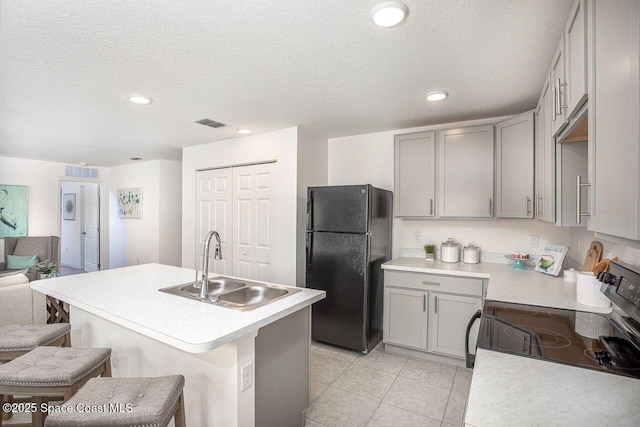 301 Latham St SE, Palm Bay, FL 32909 - kitchen with freestanding refrigerator, gray cabinetry, electric range oven, light countertops, and recessed lighting