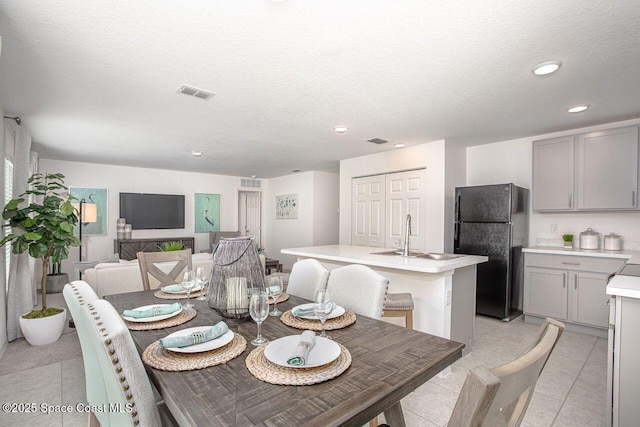301 Latham St SE, Palm Bay, FL 32909 - dining room with recessed lighting, light tile patterned floors, and a textured ceiling