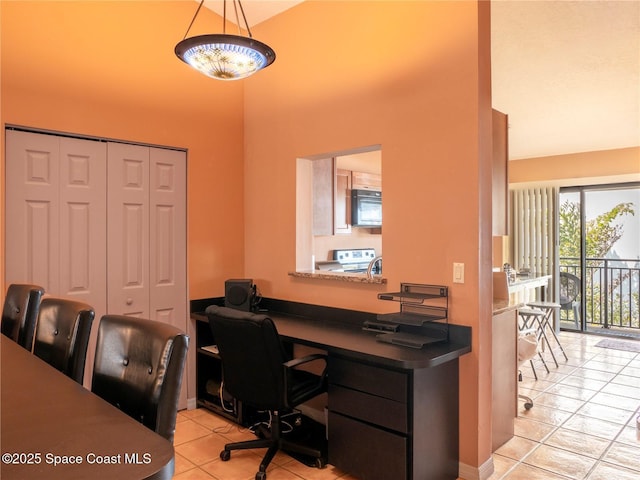 1277 S Orlando Ave Unit 4B, Cocoa Beach, FL 32931 - office area featuring a high ceiling and light tile patterned floors